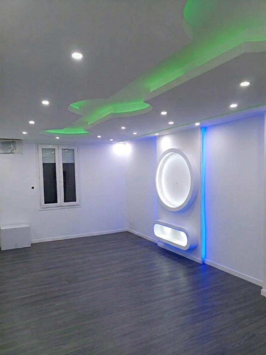 Pièce avec mur TV décoratif et plafond éclairé